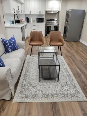 a living room with a couch and two chairs at Guest Suite in Whitby in Whitby