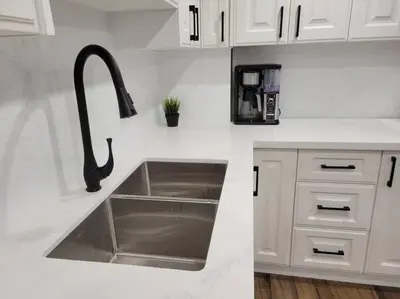 a kitchen with a sink in a white kitchen at Guest Suite in Whitby in Whitby