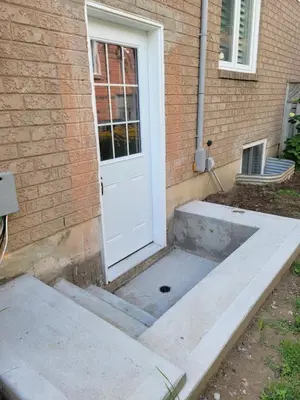 a front door of a house with a concrete floor at Guest Suite in Whitby in Whitby