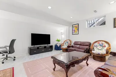 a living room with a couch and a tv at Home Away From Home in Richmond Hill