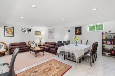 a living room with a table and leather furniture at Home Away From Home in Richmond Hill