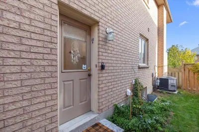 a brick house with a door with a skeleton in the window at Home Away From Home in Richmond Hill