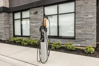 a parking meter on a sidewalk in front of a building at Holiday Inn Express & Suites Toronto Airport South by IHG in Toronto