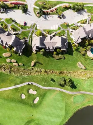 an overhead view of a golf course with a house at Rivergrass Home with Mountain and Golf Course Views in Blue Mountains