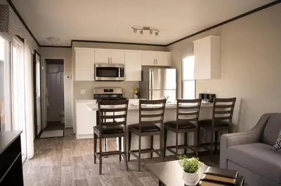 a kitchen and living room with a table and chairs at Vine Ridge Resort - Cottages in Niagara on the Lake