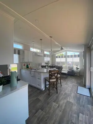 a kitchen and living room with a table and chairs at Vine Ridge Resort - Cottages in Niagara on the Lake