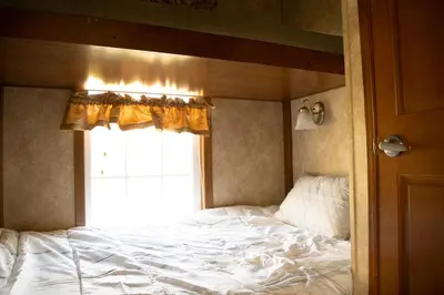 a bed in a room with a window at Vine Ridge Resort - Cottages in Niagara on the Lake