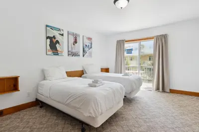 a bedroom with two beds and a window at 10 Bedroom Executive Chalet w Hot Tub in Blue Mountains