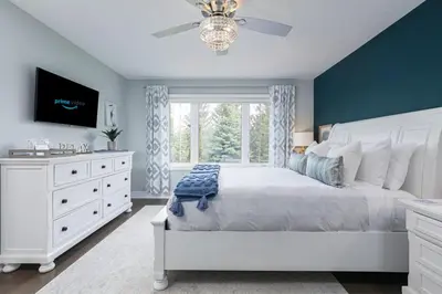 a bedroom with a white bed and a window at Exceptional 3 BDRM Townhome - 4 Seasons Rental in Collingwood