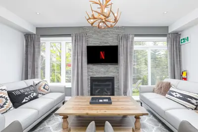 a living room with a couch and a fireplace at Exceptional 3 BDRM Townhome - 4 Seasons Rental in Collingwood