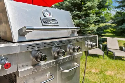 a gas grill with an umbrella in a yard at Exceptional 3 BDRM Townhome - 4 Seasons Rental in Collingwood