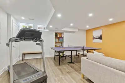 a living room with a ping pong table and a couch at Exceptional 3 BDRM Townhome - 4 Seasons Rental in Collingwood