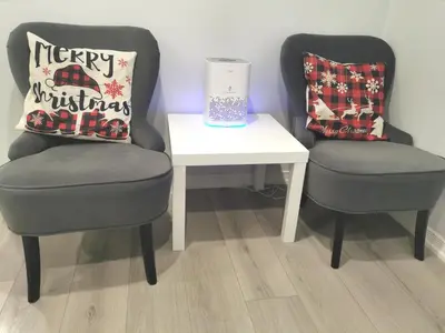 two chairs and a white table with a pillow and a lamp at Perfect location comfort private house lower level 2 bedroom unit in Mississauga