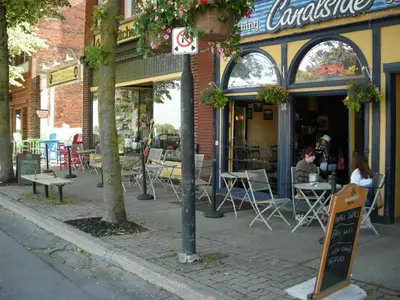 a restaurant on a street with tables and chairs at Canalside Restaurant & Inn in Port Colborne