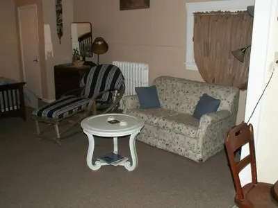 a living room with a couch and a table at Canalside Restaurant & Inn in Port Colborne