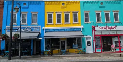 a row of colorful buildings on a city street at Canalside Restaurant & Inn in Port Colborne