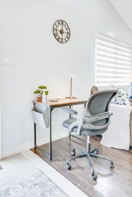 an office with a desk and a chair and a clock at Furnished Family Home near Toronto - Great Location Game Room - Backyard - Parking & Self Checkin in Pickering