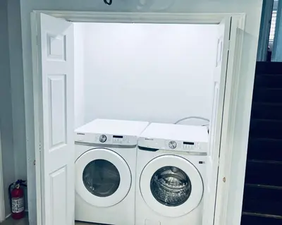 a laundry room with a washer and dryer at Furnished Family Home near Toronto - Great Location Game Room - Backyard - Parking & Self Checkin in Pickering