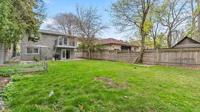a yard with a fence and a house at Furnished Family Home near Toronto - Great Location Game Room - Backyard - Parking & Self Checkin in Pickering