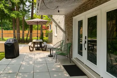 a patio with a table and an umbrella at Furnished Family Home near Toronto - Great Location Game Room - Backyard - Parking & Self Checkin in Pickering