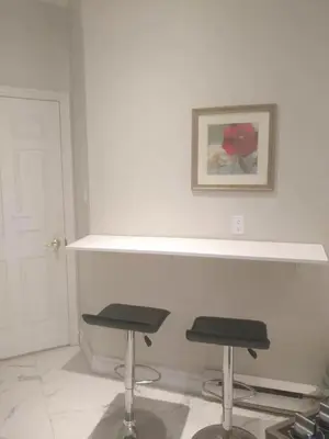 a white room with two stools and a picture on the wall at Lakeview private suite-Twin or king in Tottenham