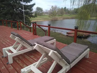 a hammock on a deck next to a body of water at Lakeview private suite-Twin or king in Tottenham