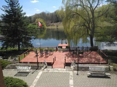 a dock with tables and chairs next to a lake at Lakeview private suite-Twin or king in Tottenham