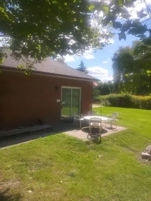 a patio with a table and chairs in a yard at Lakeview private suite-Twin or king in Tottenham