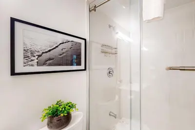a bathroom with a shower and a picture on the wall at Condo 204 at North Creek Resort in Blue Mountains