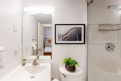 a bathroom with a toilet and a sink and a mirror at Condo 204 at North Creek Resort in Blue Mountains
