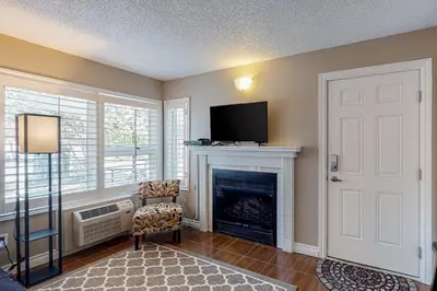 a living room with a fireplace and a flat screen tv at Condo 204 at North Creek Resort in Blue Mountains