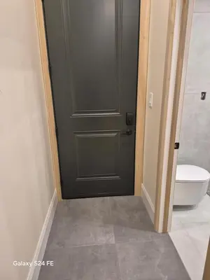a bathroom with a green door and a toilet at Gabby's Place Downtown Core in Toronto