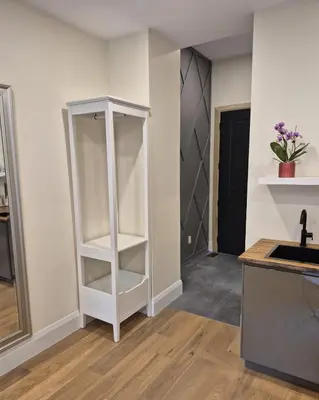 a kitchen with a white book shelf next to a sink at Gabby's Place Downtown Core in Toronto