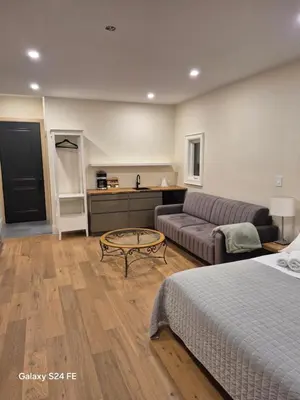 a room with a bed and a couch and a table at Gabby's Place Downtown Core in Toronto