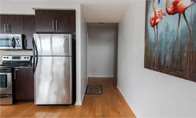 a kitchen with a stainless steel refrigerator in a room at Toronto Downtown Core Two Bedroom Condo with CN Tower View, Free Parking in Toronto