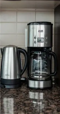 two coffee pots sitting on top of a counter at Toronto Downtown Core Two Bedroom Condo with CN Tower View, Free Parking in Toronto