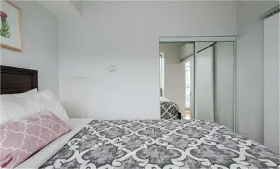 a bedroom with a bed and a mirror at Toronto Downtown Core Two Bedroom Condo with CN Tower View, Free Parking in Toronto
