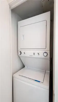 a white washer and dryer in a small room at Toronto Downtown Core Two Bedroom Condo with CN Tower View, Free Parking in Toronto