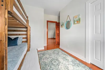 a bedroom with a bunk bed and a hallway at Unique Log House by the Lake, Retreat with Spa Amenities near Presque'ile Provincial Park in Brighton