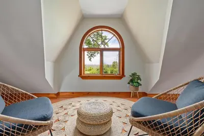 a living room with two chairs and a window at Unique Log House by the Lake, Retreat with Spa Amenities near Presque'ile Provincial Park in Brighton