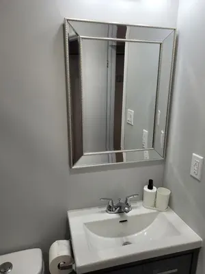 a bathroom with a sink and a mirror at Guest House Basement - Master Bedrooms in Bayview Village in Toronto