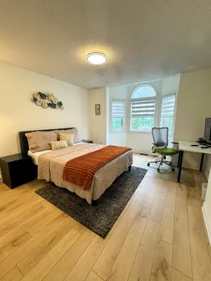 a bedroom with a bed and a desk and a chair at The Khan Villa in Whitby