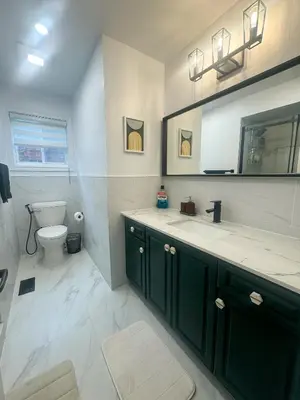 a bathroom with a toilet and a sink and a mirror at The Khan Villa in Whitby