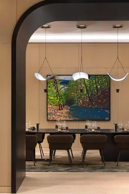 a dining room with a large painting on the wall at Canopy By Hilton Toronto Yorkville in Toronto