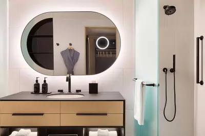 a bathroom with a sink and a mirror at Canopy By Hilton Toronto Yorkville in Toronto