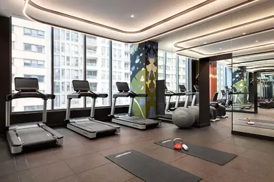 a gym with treadmills and exercise equipment in a building at Canopy By Hilton Toronto Yorkville in Toronto