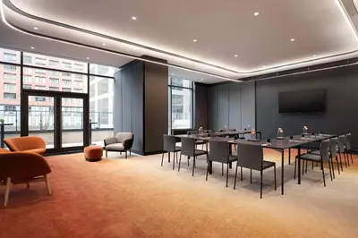 a conference room with tables and chairs and a tv at Canopy By Hilton Toronto Yorkville in Toronto