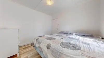 a bedroom with a bed with a comforter on it at Main Beach River Retreat - Wasaga Beach 1 - Main Strip - 93 Mosley St in Wasaga Beach