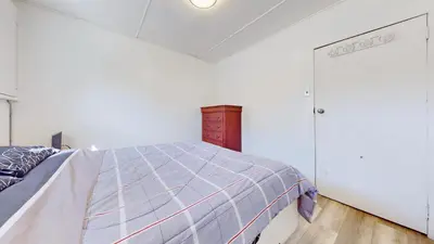 a white bedroom with a bed and a closet at Main Beach River Retreat - Wasaga Beach 1 - Main Strip - 93 Mosley St in Wasaga Beach