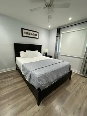 a bedroom with a bed and a ceiling fan at Spectacular 3 BR 2 WR House - Close to Airport in Toronto